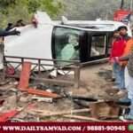 People looking at the damaged car in the accident