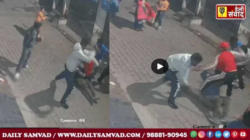 Miscreants beating Anil in the middle of the road.