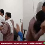 Villager pulling Dharmpal Sharma's companion (wearing a checked shirt) by his hand.