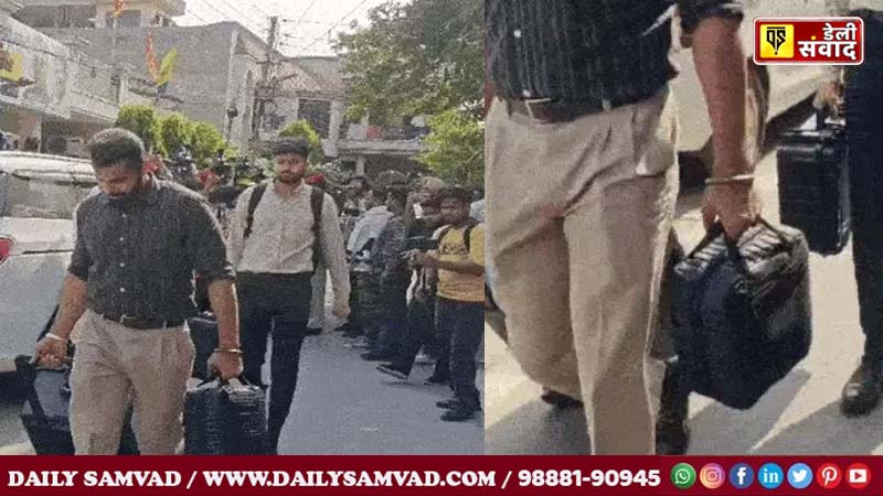 Members of the vigilance team taking away documents in a bag from inside the MLA's house.