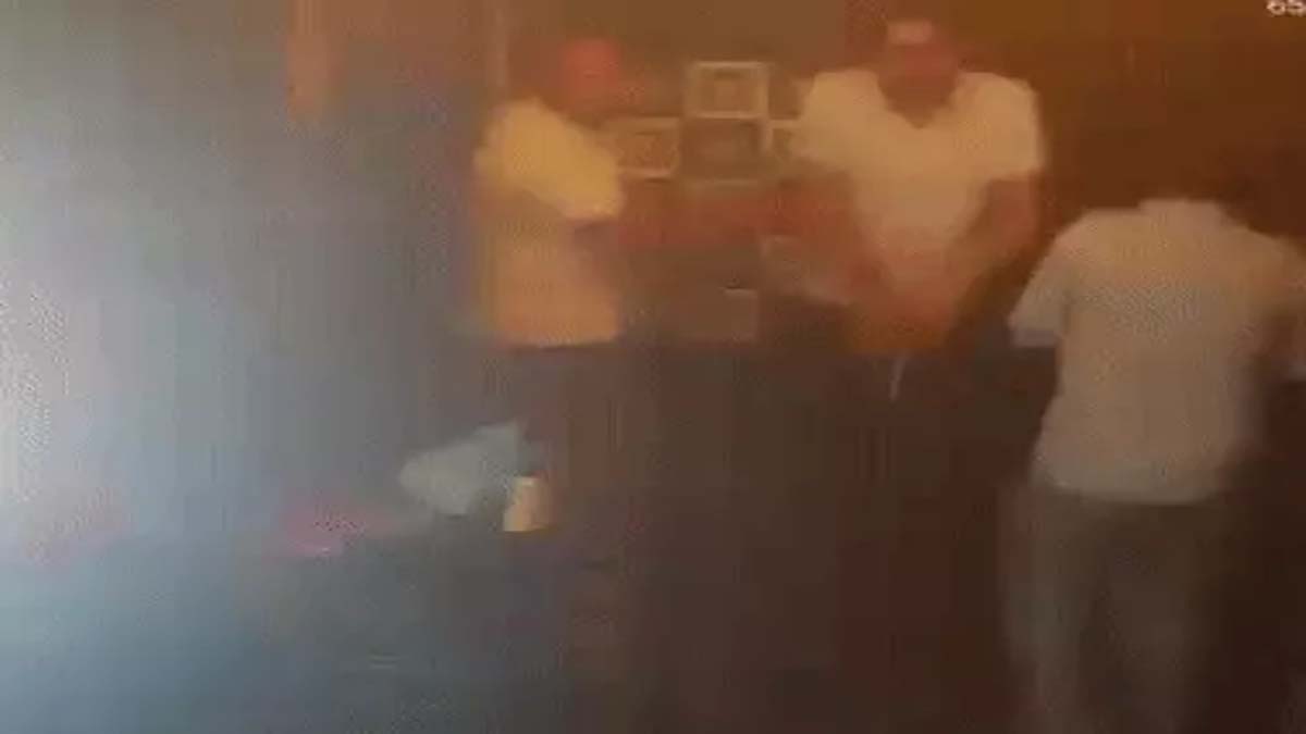 A young man firing in a club.