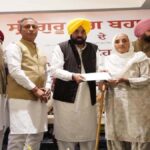 CM Mann distributed cheques