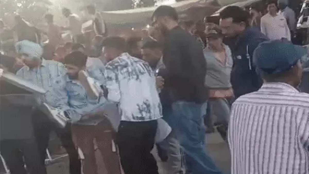 People shifting the injured man to an ambulance.