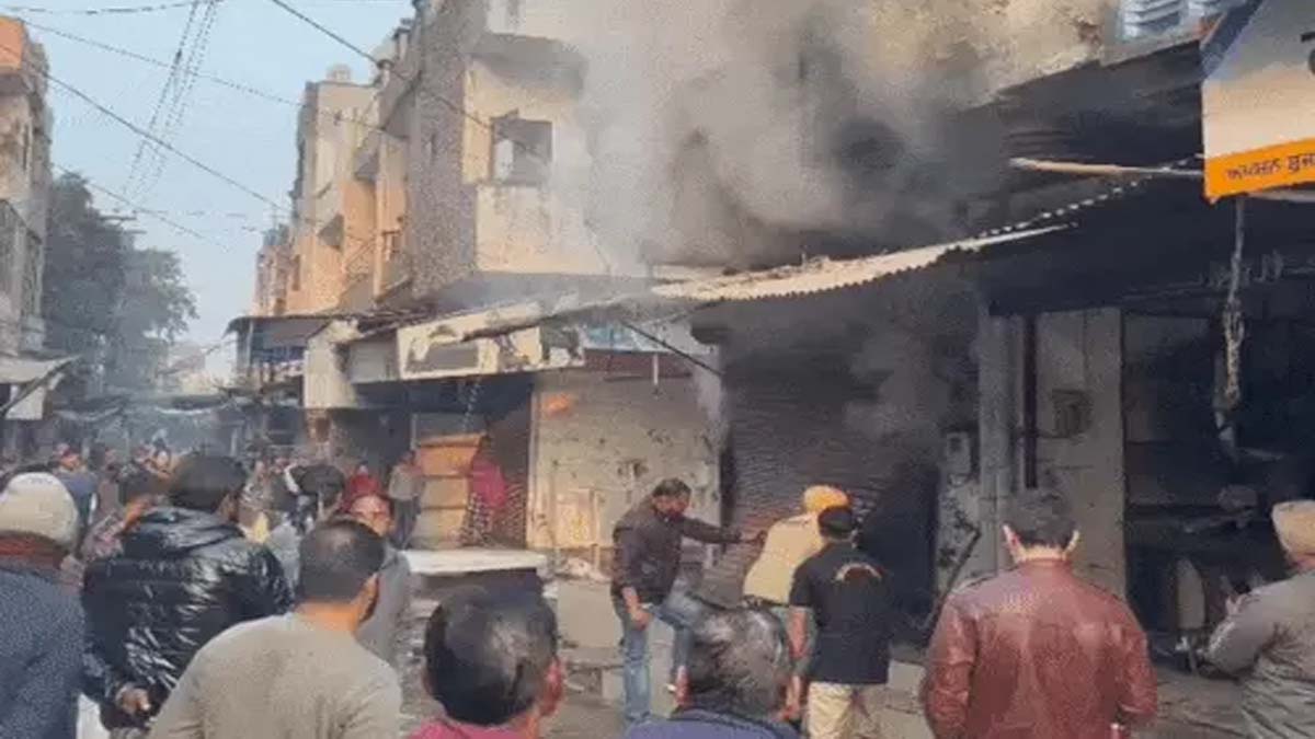 People breaking down the shop's shutters after the fire.