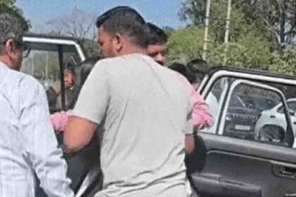 The mayor taking the injured girl to the hospital after the accident.