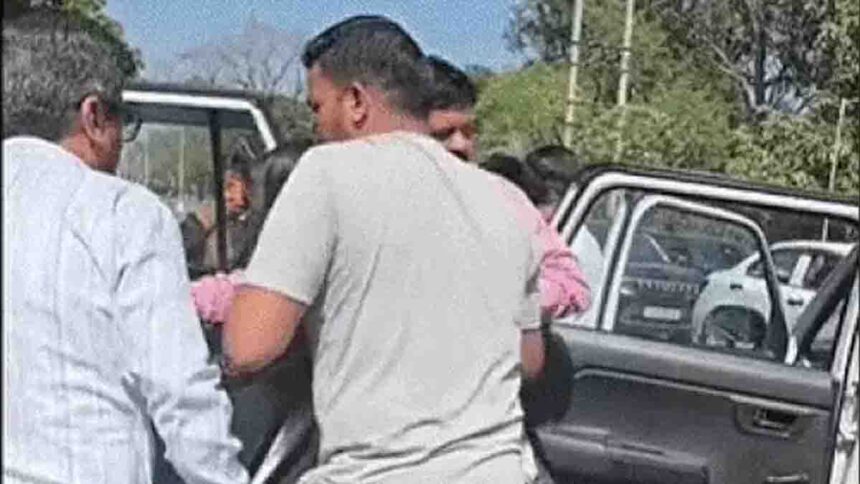 The mayor taking the injured girl to the hospital after the accident.